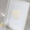 A white frame with a heart on it