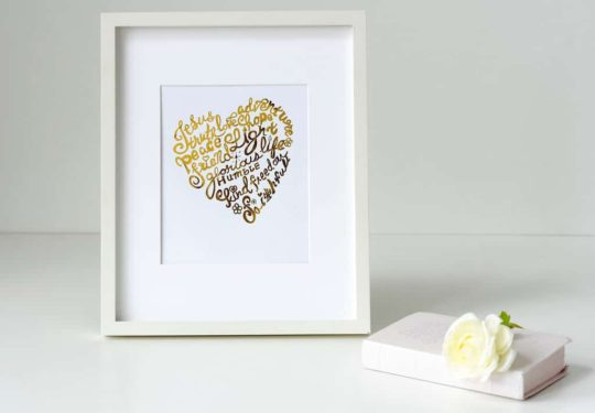 A white frame with a gold heart on it