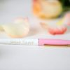 A pink pen sitting on top of a table.