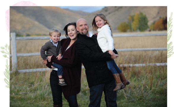 A family posing for a picture in the grass.