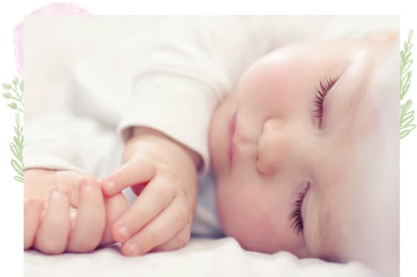 A baby sleeping on top of the bed.