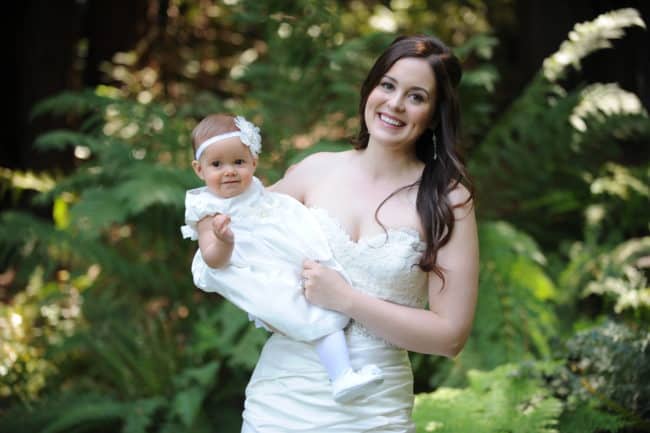 A woman holding a baby in her arms.